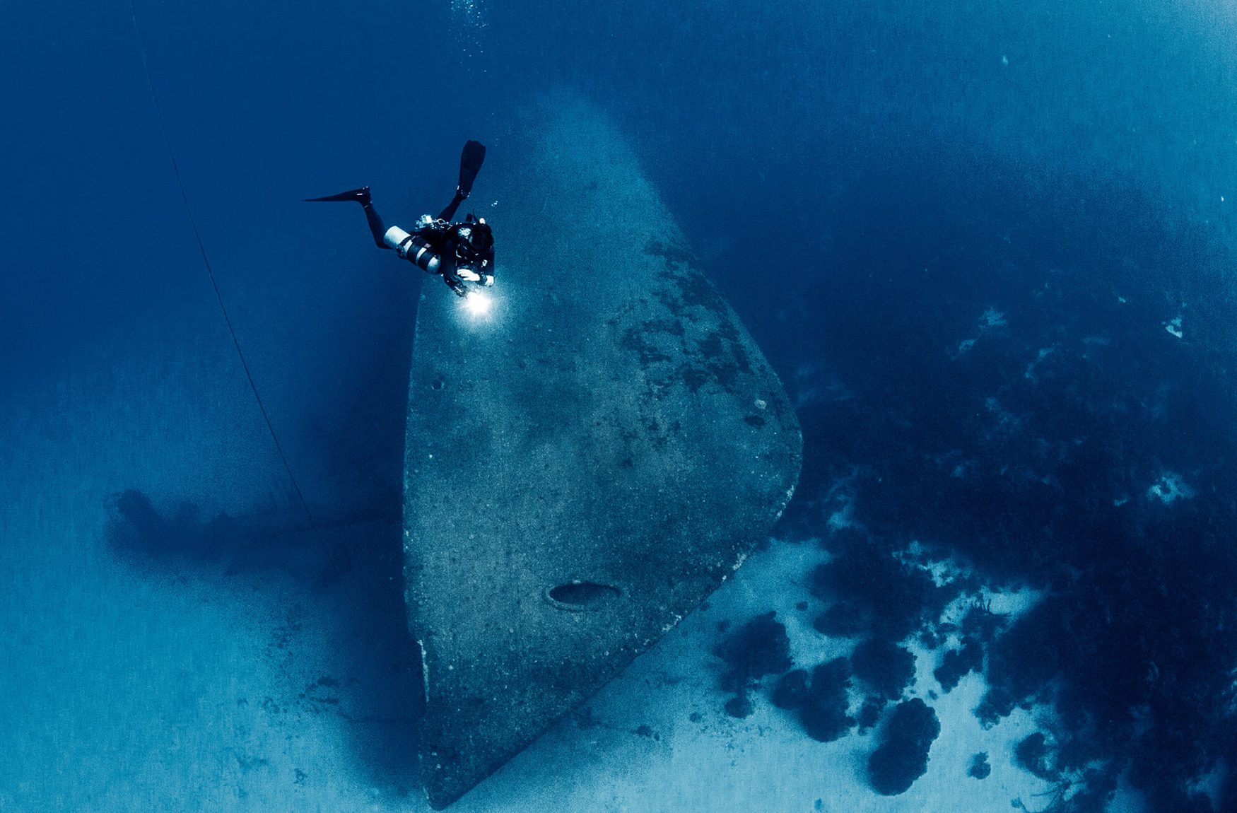 Diver diving in a shipwreck